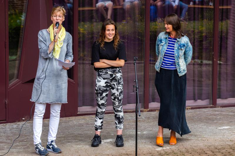 Leerlinge en docenten op het podium